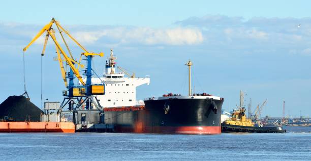 istock Cargo ship in the port on a sunny day 1013224384