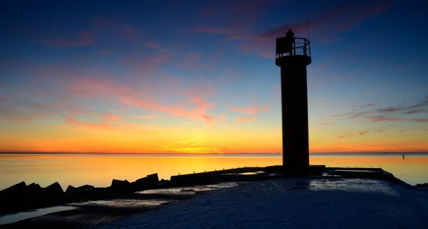 istock lighthouse in the sea at the colorful sunset 1013234376