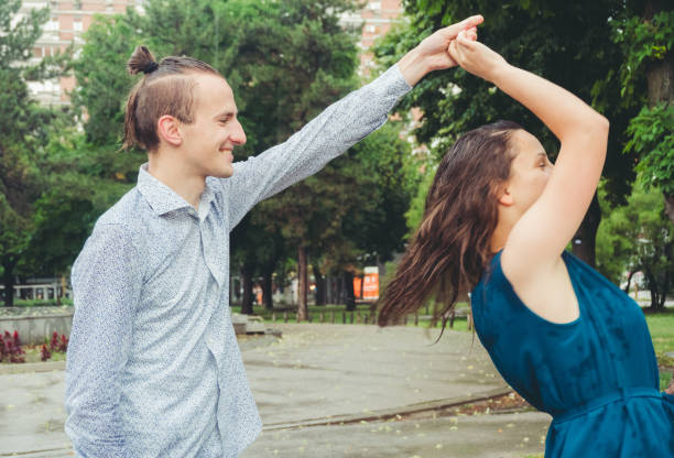 istock Happy couple dancing in the rain 1013234696