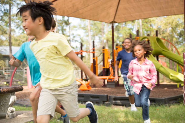 istock Multi-ethnic group of school children running on school playground. 1013268076