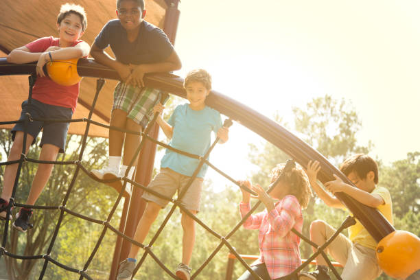 istock Multi-ethnic group of school children playing on school playground. 1013268178