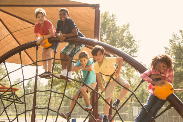 istock Multi-ethnic group of school children playing on school playground. 1013268318