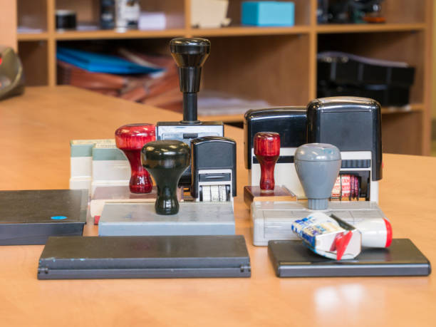 Business: Close-up of a female clerk in her office with papers and stamps