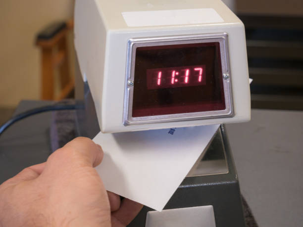 Electronic time recorder machine in an office stock photo