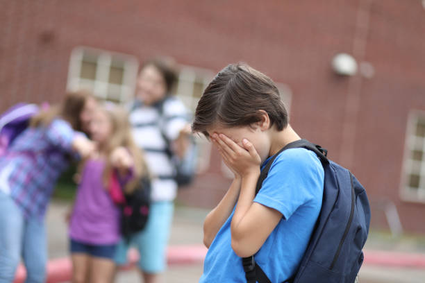 istock Elementary age boy being bullied at school. 1013275194