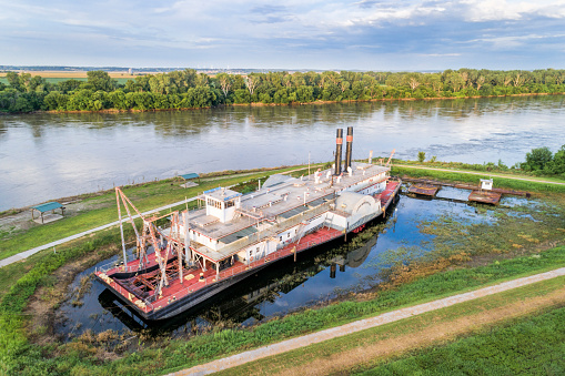 Brownville, NE, USA - July 29, 2018:  Historic dredge, Captain Meriwether Lewis, in a dry dock on a shore of Missouri River.