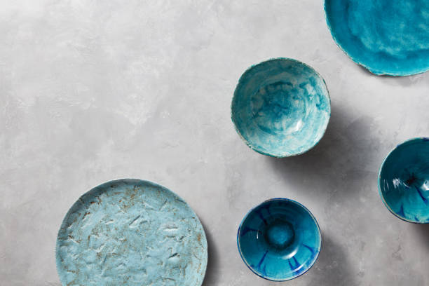 istock Porcelain blue bowls and plates on a gray marble table. Multi-colored ceramic vintage handmade dishes 1013280634