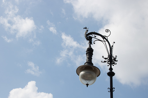Old street lamp in front of an old building in Valencia, Spain