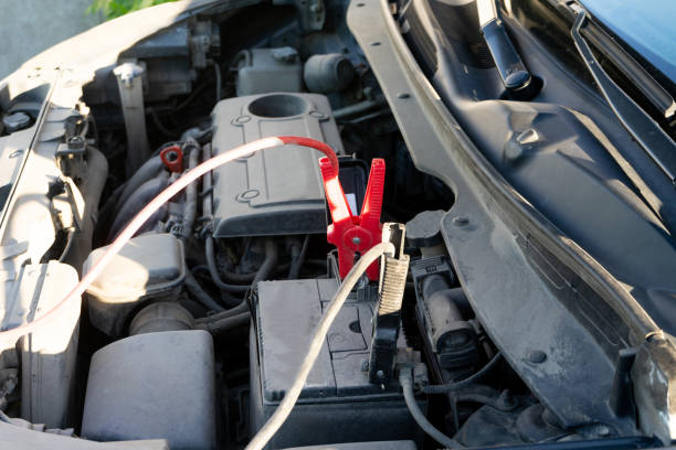 istock A Car battery Jumper Cables with copper clamps attached to the terminals. 1013316546