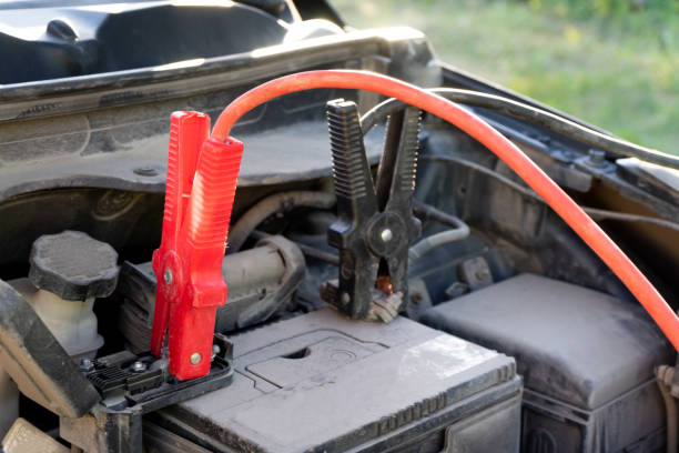 istock A Car battery Jumper Cables with copper clamps attached to the terminals. 1013318962