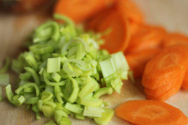 Close up photo of Carrot, onion and leek sliced on a chopping board. Preparing lunch dinner - cooking.