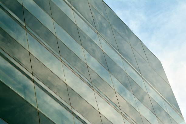 istock Sky and clouds reflecting on a building with mirrored glass 1013340150