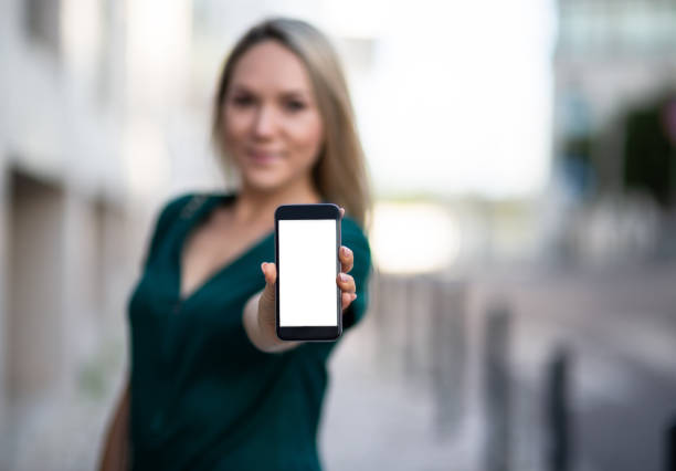 istock Woman showing a blank smartphone screen 1013358640