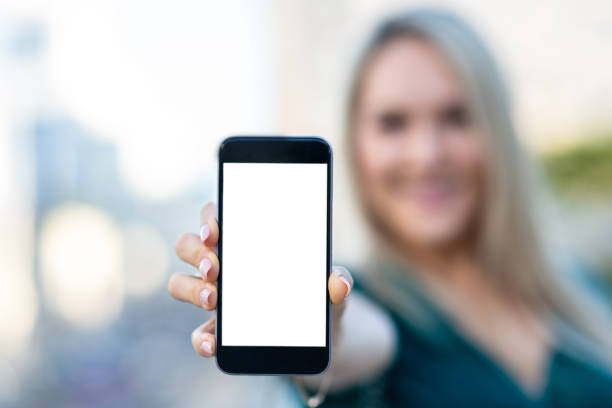 istock Woman showing a blank smartphone screen 1013358692