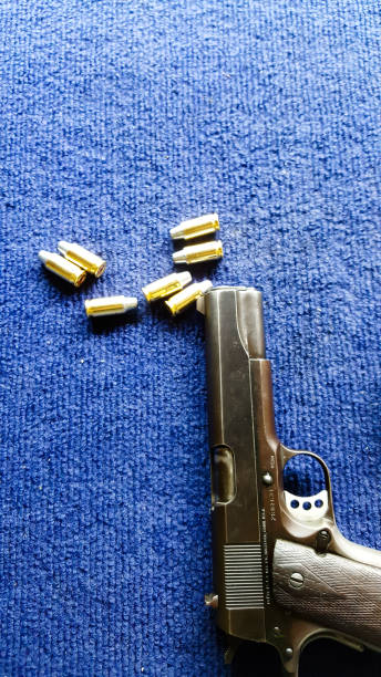 istock Pistol and bullets on white background 1013374680