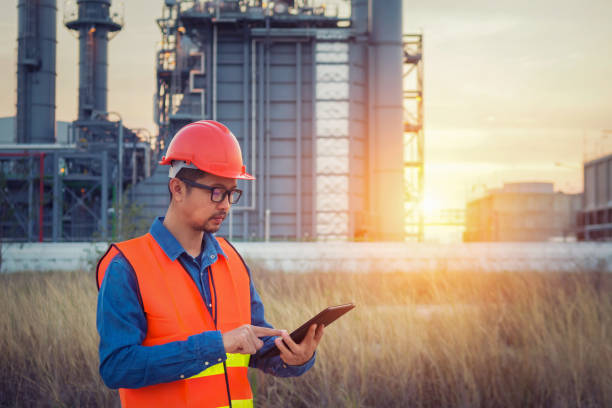 istock Engineer working with tablet PC at construction site near power plant at senset 1013414280