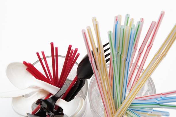 istock Plastic straws, cutlery and twizzle sticks in glasses 1013417098