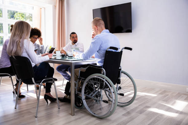 istock Disabled Manager Sitting With His Colleagues 1013419454