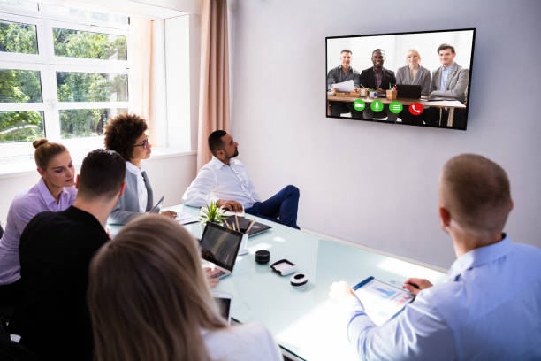 istock Businesspeople Video Conferencing In Boardroom 1013419468