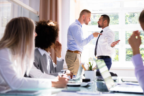 Two Male Colleagues Fighting In Office Stressed Businesspeople Sitting In Front Of Two Colleagues Fighting In Office spar stock pictures, royalty-free photos & images