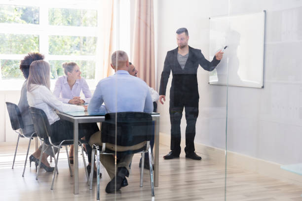 istock Businessman Giving Presentation To His Executives 1013419652