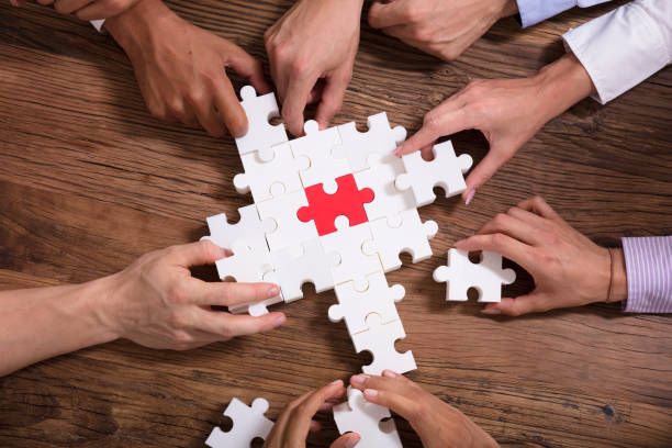 istock Elevated View Of Businesspeople Solving Jigsaw Puzzle 1013419864