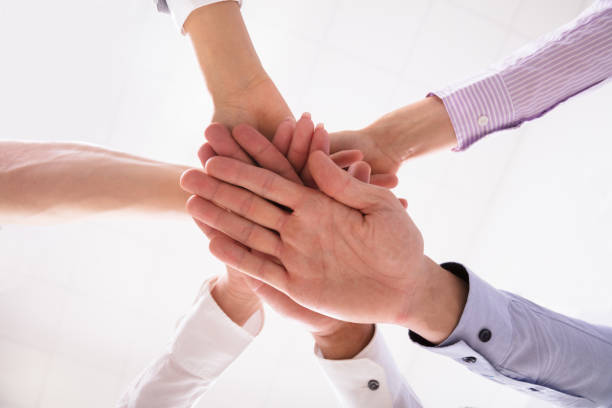 istock Close-up Of Businesspeople Stacking Hands 1013421988