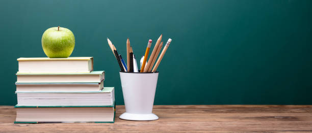 istock Green Apple On Top Of Stacked Books 1013427738