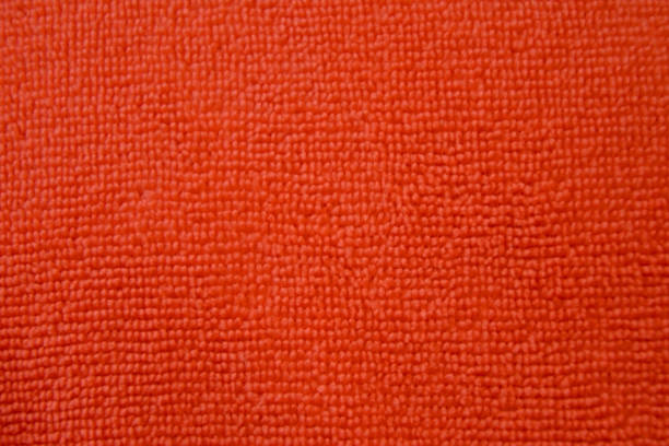 istock Background of red microfiber cloth. Texture of fabric for cleaning 1013432384
