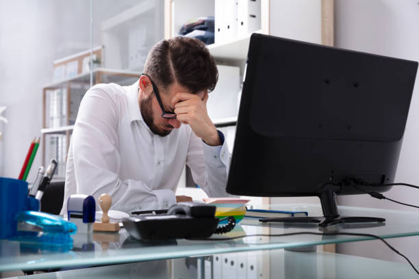 istock Tired Young Businessman Sitting In Office 1013432842