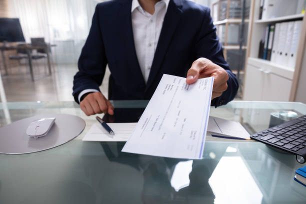 istock Businessman Giving Cheque 1013432874