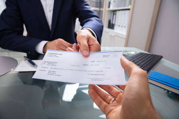 istock Businessman Giving Cheque 1013432894