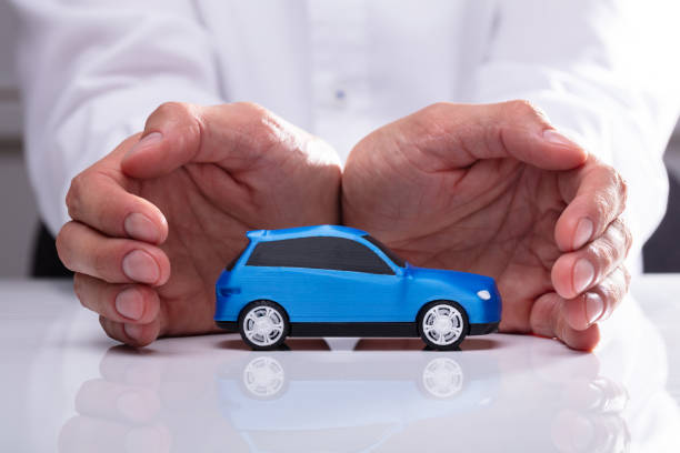istock Businessman Protecting Blue Car 1013435010