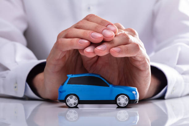 istock Businessman Protecting Blue Car 1013435026