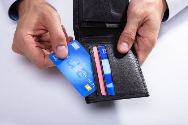 istock Person Removing Credit Card From Wallet 1013435054