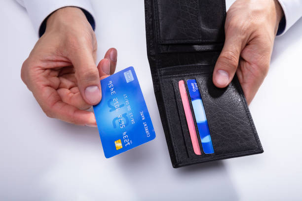 istock Person Removing Credit Card From Wallet 1013435068