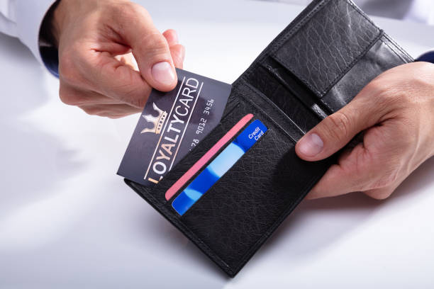 istock Human Hand Removing Loyalty Card From Wallet 1013435076