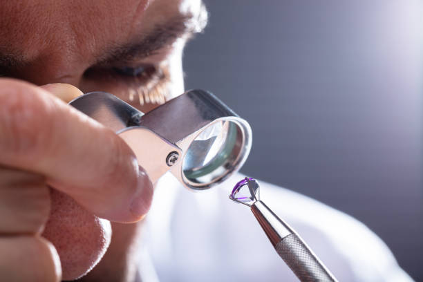 istock Jeweler Looking At Diamond Through Magnifying Loupe 1013435142