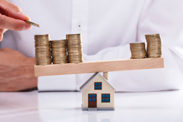 istock Businessman Stacking Coins On Seesaw 1013435166