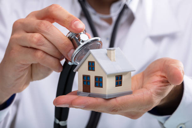 istock Doctor Examining House Model With Stethoscope 1013435460