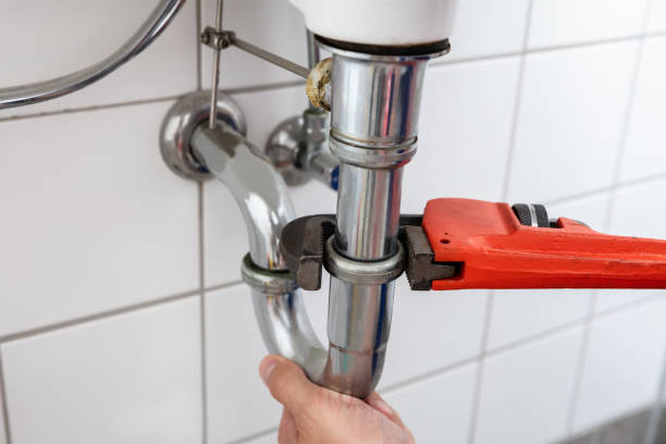 istock Plumber Repairing Sink With Adjustable Wrench 1013437696