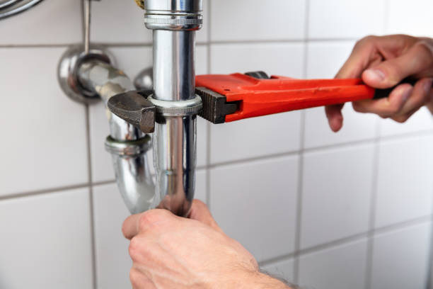 istock Plumber Repairing Sink With Adjustable Wrench 1013437698
