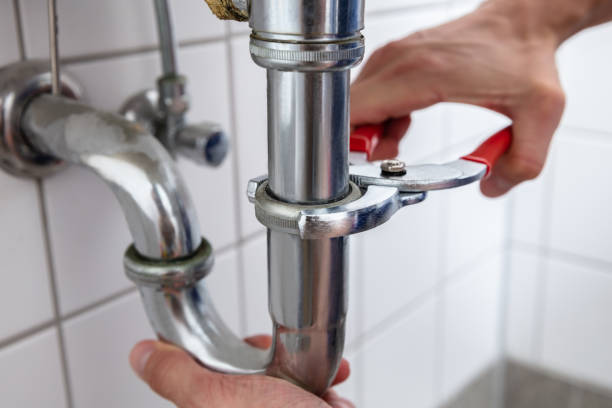 istock Plumber Repairing Sink With Adjustable Wrench 1013437702