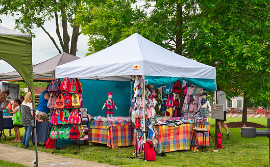 Twinsburg, OH, USA - June 9, 2018: A home goods and fabrics craft booth sports a colorful display at A Taste of Twinsburg, an outdoor culinary and arts festival held one Saturday in summer on the town square.