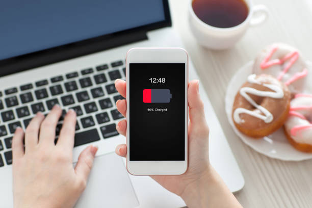 istock female hands holding white phone with low charged battery screen 1013445198