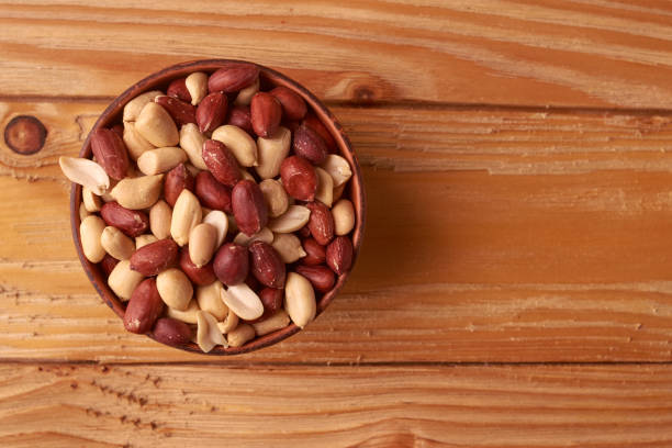 istock walnut peanut in clay bowl. peanuts for food textures. peanut harvest. fried peanuts. texture of the nuts. photo for layout. Copyspace 1013447652