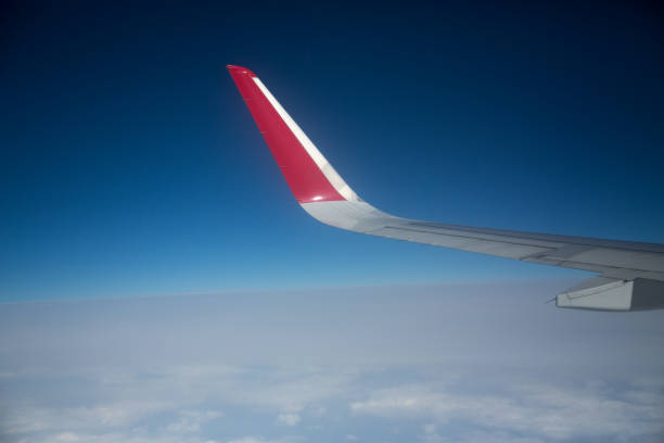istock Clouds and sky as seen through window of an aircraft 1013452664