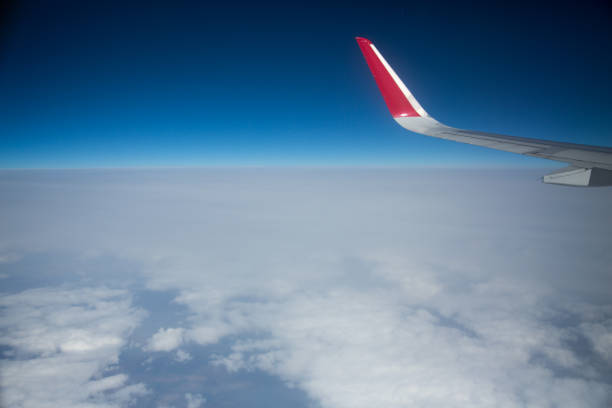 istock Clouds and sky as seen through window of an aircraft 1013452784
