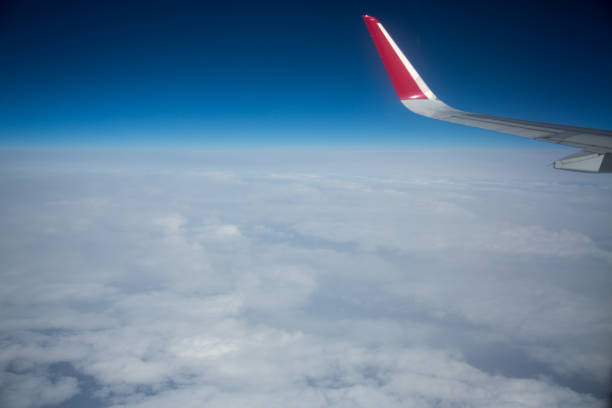 istock Clouds and sky as seen through window of an aircraft 1013452816