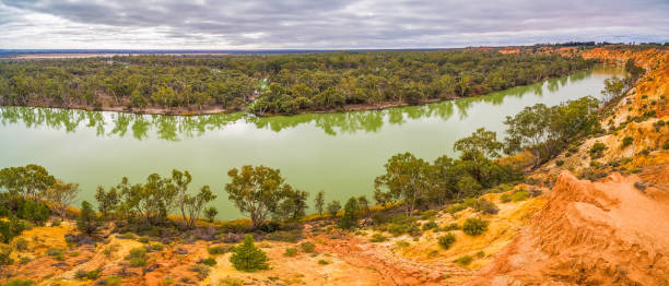 istock Orange sandstone cliffs and gum trees over Murray River in South Australia 1013485622
